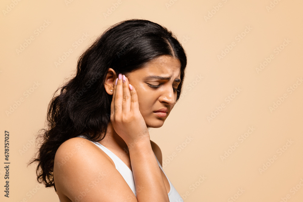 Headache Concept. Portrait of stressed young indian woman suffering from migraine Headache Concept. Portrait of stressed young indian woman suffering from migraine