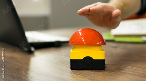Cuadro en lienzo Hand reaches out to hit a buzzer in a office.