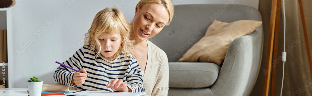 blonde little girl drawing on paper with colorful pencils near supportive mother at home, banner blonde little girl drawing on paper with colorful pencils near supportive mother at home, banner