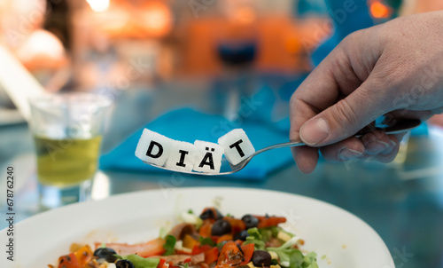 The German word 'diaet' (diet) on a spoon in a restaurant. Symbol for having too much sugar in most dishes.