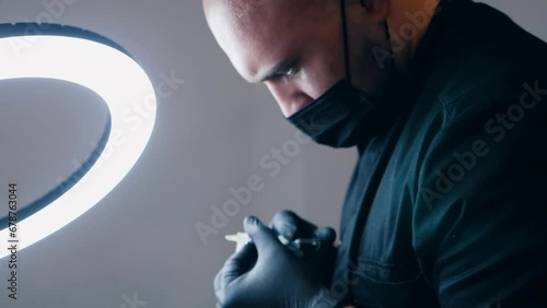 A doctor in a mask holds a syringe in a medical clinic.  The doctor prepares a syringe for injection. Close up. medical office. lip augmentation procedure. beauty injections. Plastic surgery. photo