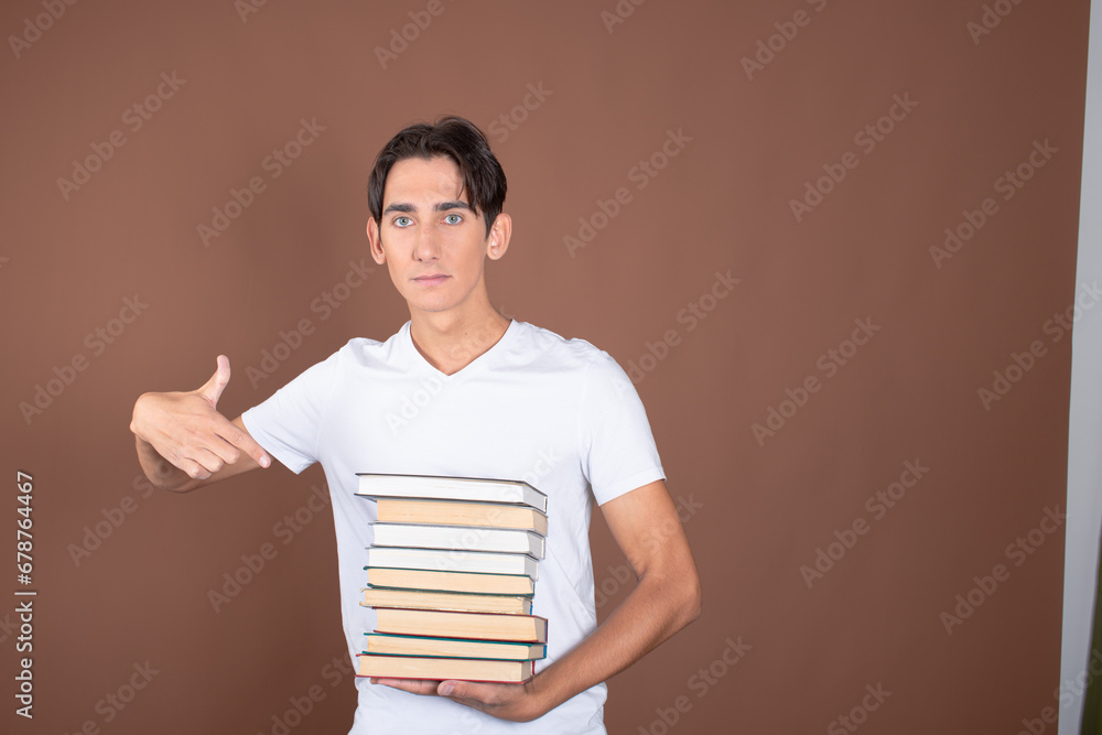 Young man and study. Funny attractive guy posing on a brown background. Young man and study. Funny attractive guy posing on a brown background.