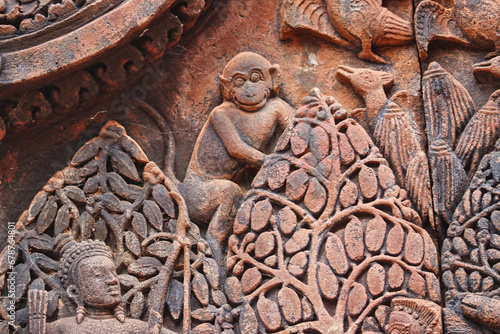 Money Stone Bas relief from hindu mythology at Banteay Srei - 10th century Hindu temple and masterpiece of old Khmer architecture at Siem Reap, Cambodia, Asia photo