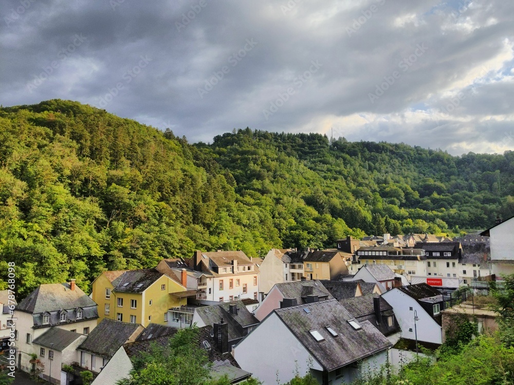 Landscape of a beautiful cozy town in the green forested hills
