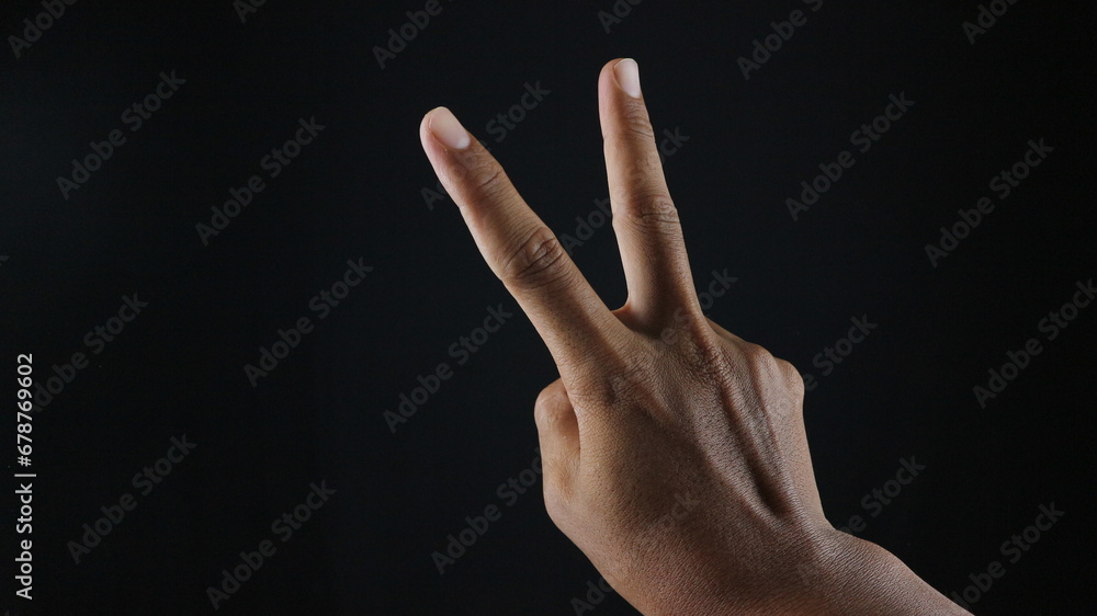 Hand with two fingers up in the peace or victory symbol Hand with two fingers up in the peace or victory symbol