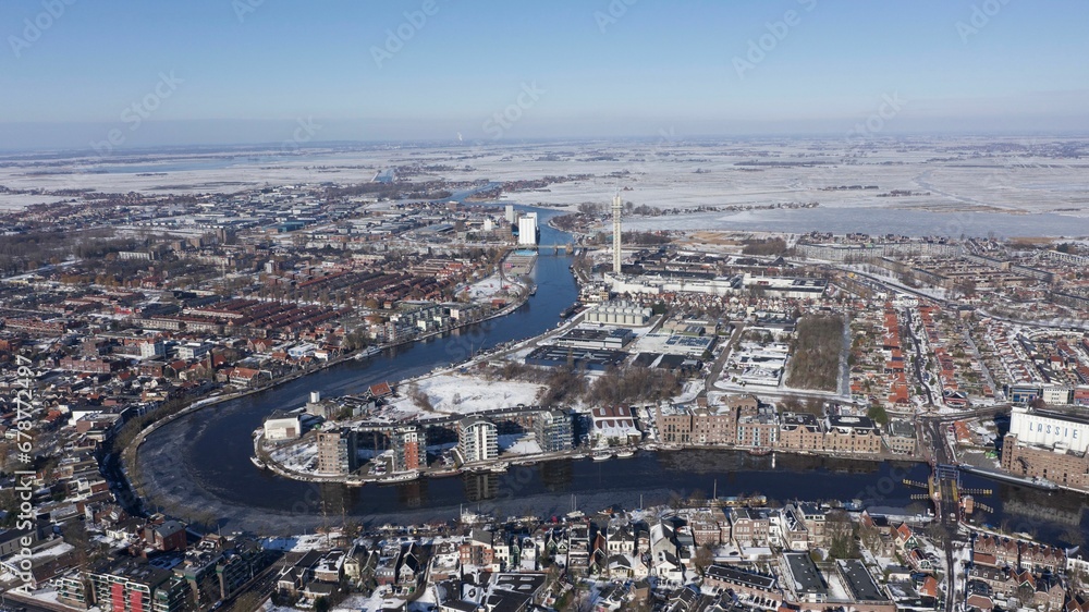 Aerial view of a snowy city with a river