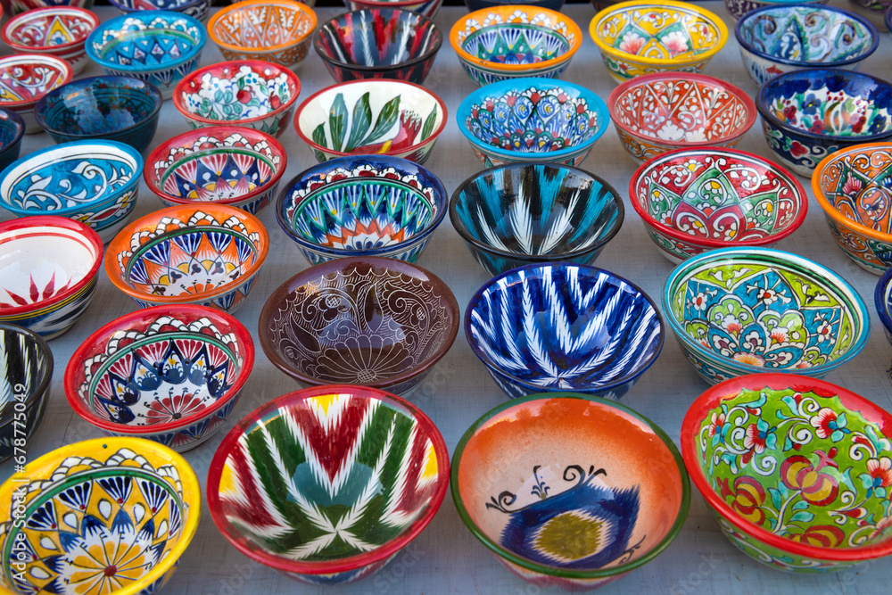 Multi-colored bright bowls with traditional national painting. Souvenir tableware of Uzbekistan
