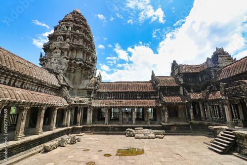 A view of the main gallery and quadrangle of the Angkor Wat temple complex from the top of the temple with surrounding countryside at Siem Reap, Cambodia, Asia photo
