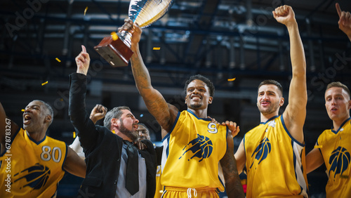 Multiethnic Basketball Players Celebrate Championship Victory with Hugs  Jumping  Holding the Trophy. Exclusive Joyful Sports Action on Live TV and Pay Per View Internet Streaming Concept.