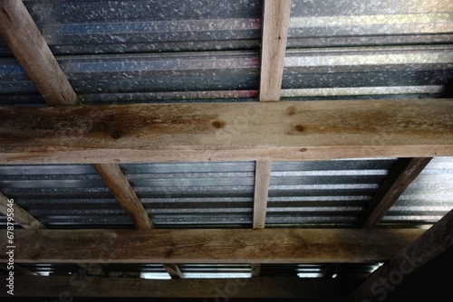 Metal roof with a ceiling made of spruce beams