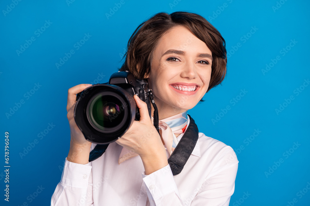 Portrait of charming cheerful person toothy smile hands hold photo camera isolated on yellow color background Portrait of charming cheerful person toothy smile hands hold photo camera isolated on yellow color background