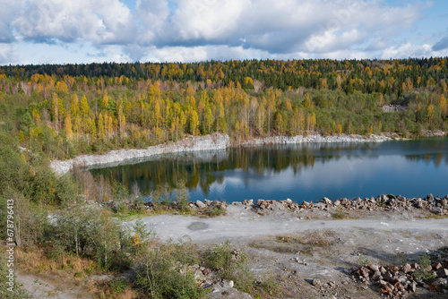 View of the old flooded marble quarry in the vicinity of Ruskeala in golden autumn. Karelia, Russia