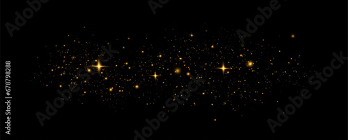 Golden sequins glow with many lights. Glittering dust. Luxurious background of golden particles.	