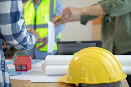 Yellow safety helmet were prepared for workers to wear before entering the construction area to prevent the danger of falling objects from working. Yellow safety helmet is placed on a wooden table.