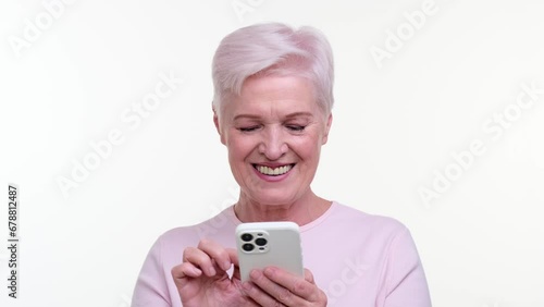 Wallpaper Mural Contented elderly caucasian woman effortlessly utilizes smartphone. Her eyes twinkle with satisfaction, capturing a moment of seamless technology integration. Torontodigital.ca