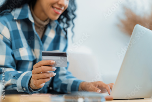 Fototapeta Naklejka Na Ścianę i Meble -  Close up credit card using for online payment, banking and shopping on the internet network with laptop computer showing credit card technology for online secured wallet top up and crucial purchase