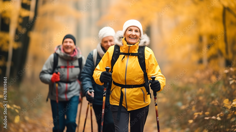 Active hiking rest outdoors of mature couple concept. Senior elderly man and woman training Nordic walking with ski trekking poles in autumn forest