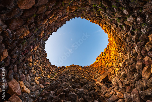 Inside of the bronze age fort UNESCO world heritage site Su Nuraxi di Barumini on Sardinia island during sunset.  photo