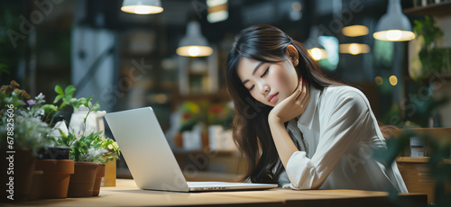 asian businesswoman working in the office with eye strain from the computer photo