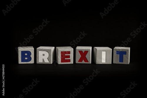 Word BREXIT written with wooden cubes. Studio shot of some arranged wooden blocks with a textual message.