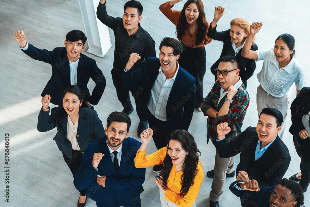 Happy diverse business people celebrating their success project.Top view. Group of successful energetic employees cheer up gratefully while looking at sky with white background. Intellectual.