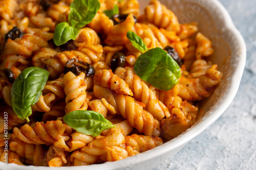 Basil leaves on pasta with arabiata sauce