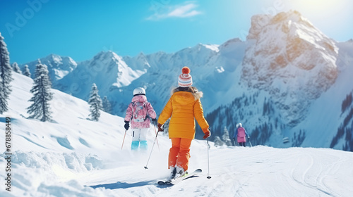 
Child skiing in the mountains. Kid in ski school. Winter sport for kids. Family Christmas vacation in the Alps. Children learn downhill skiing. Alpine ski lesson for boy and girl. Outdoor snow fun. photo