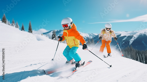  Child skiing in the mountains. Kid in ski school. Winter sport for kids. Family Christmas vacation in the Alps. Children learn downhill skiing. Alpine ski lesson for boy and girl. Outdoor snow fun.