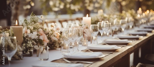 In the serene background of a vintage restaurant a beautifully designed table adorned with white floral arrangements and summer flowers captured the essence of nature and love adding a touch photo