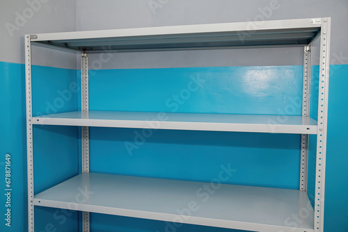Empty metal racks with shelves for storing things.