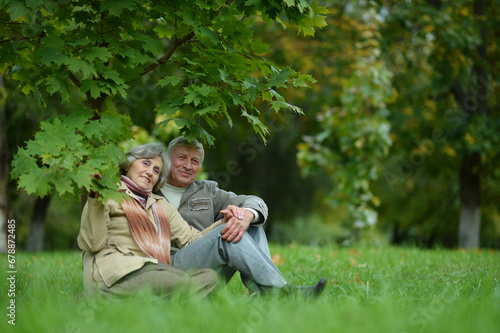 Cute elderly couple outdoors in a fall park. 