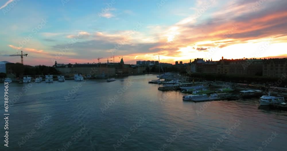 Aerial Forward Shot Of Ferries On Sea By Buildings In City During Sunset Against Sky - Stockholm, Sweden Aerial Forward Shot Of Ferries On Sea By Buildings In City During Sunset Against Sky - Stockholm, Sweden
