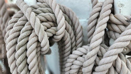 Close-up shot of details of sail rope on the mast of sailboat. Marine equipment, sea knot, journey