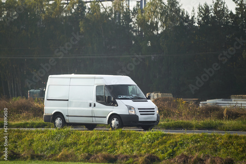 A fast and reliable delivery service with a commercial van on the road. Delivery truck on the highway road. Courier shipping truck.