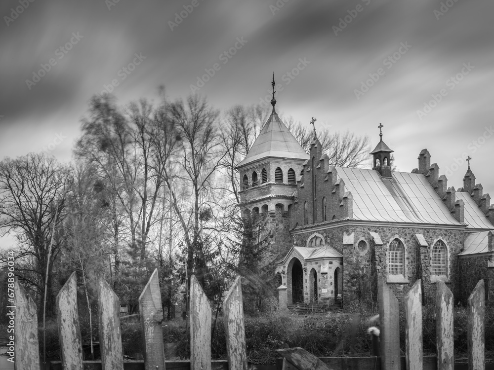smooth clouds in long exposure above old cathedral in Ukraine in black and white style