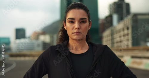 Fitness, breathe and face of woman in the city for race, marathon or competition training. Serious, sports and portrait of young female athlete runner on a break for running cardio workout in town. photo