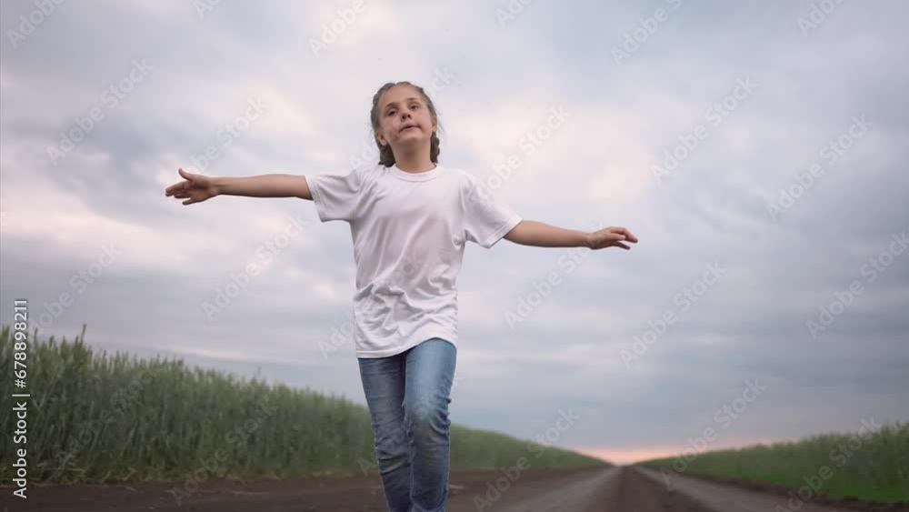 girl child running in nature in the park. happy family kid dream concept. free child daughter runs along a rural road next to a field in nature. free girl lifestyle runs and plays in the park girl child running in nature in the park. happy family kid dream concept. free child daughter runs along a rural road next to a field in nature. free girl lifestyle runs and plays in the park