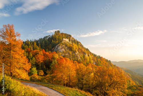 View of autumn landscape with The ruin of the medieval Vrsatec castle at sunset. The Vrsatec National Nature Reserve in the White Carpathian Mountains, Slovakia, Europe. photo