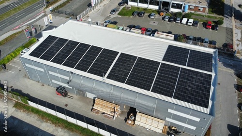 Aerial view of a building's roof with solar panels on a sunny day