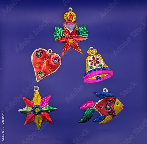 Mexican tin christmas decorations in christmas tree shape, blue background