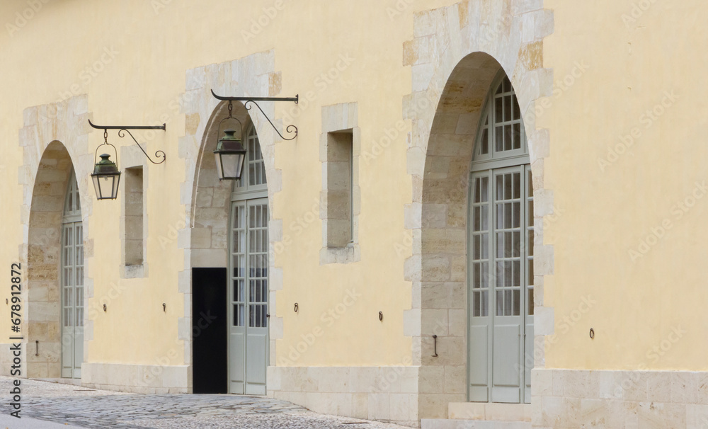 Row of three arched doorways with doors