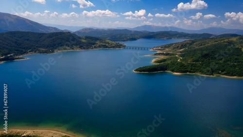 Aerial shot of the Campotosto Lake in Abruzzi  Italy with a bridge over it