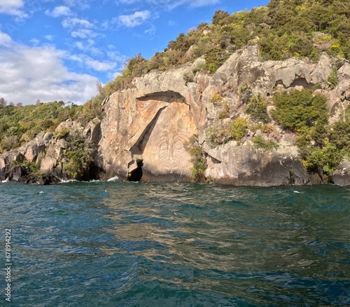 View of Lake Taupo and Maori rock carvings at Mine Bay. New Zealand.