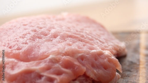 Obraz na plátně Close-up shot of Tenderizing Pork Chops on Wooden Board with Hammer