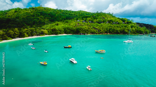 Summer landscape on a tropical island. Tropical landscape with sunny sky. Tropical beach, ocean with boats. Seyshelles, Mahe, Port Launay Beach photo