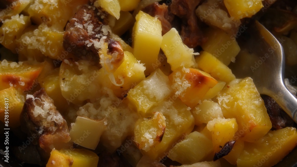 High angle shot of Baked Potato and Meat Skillet with Grated Cheese. High angle shot of Baked Potato and Meat Skillet with Grated Cheese.