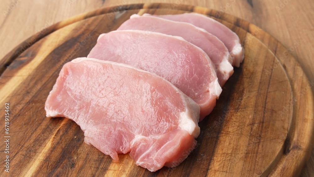 Pull back shot of Sliced Pork Loin on Wooden Board. Pull back shot of Sliced Pork Loin on Wooden Board.