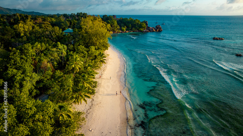 Aerial view Top down seashore. Beautiful azure sea surface in sunny day summer background Amazing seascape top view seacoast at Anse Severe Beach, La Digue Seychelles photo