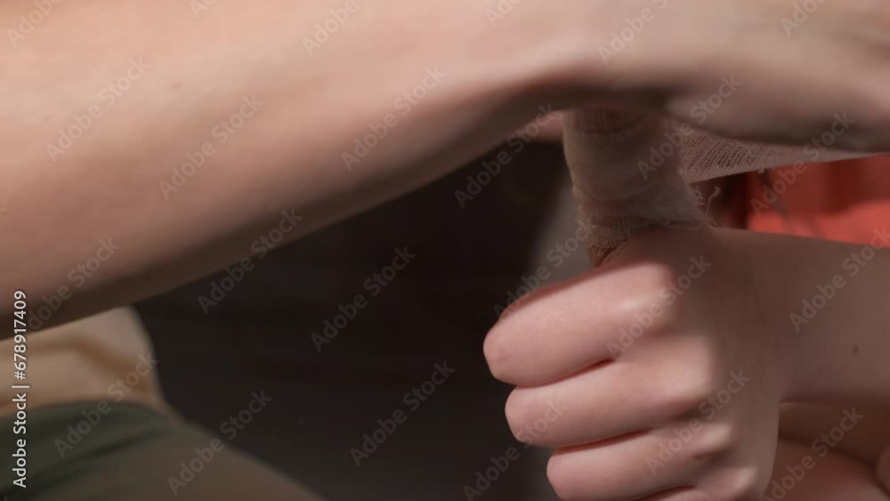 Mother bandaging the injured finger. A female help to make a finger bandage to child. Mother bandaging the injured finger. A female help to make a finger bandage to child.