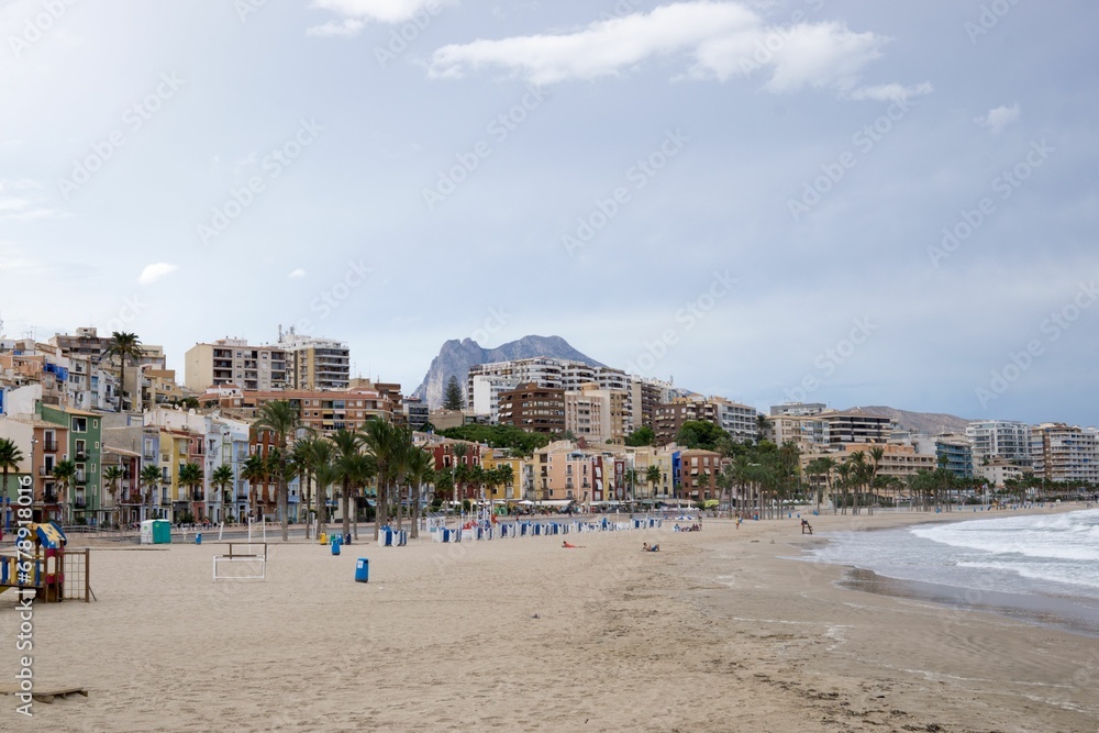 Sea waves splashing over the shore with the city in the background, Alicante, Spain
